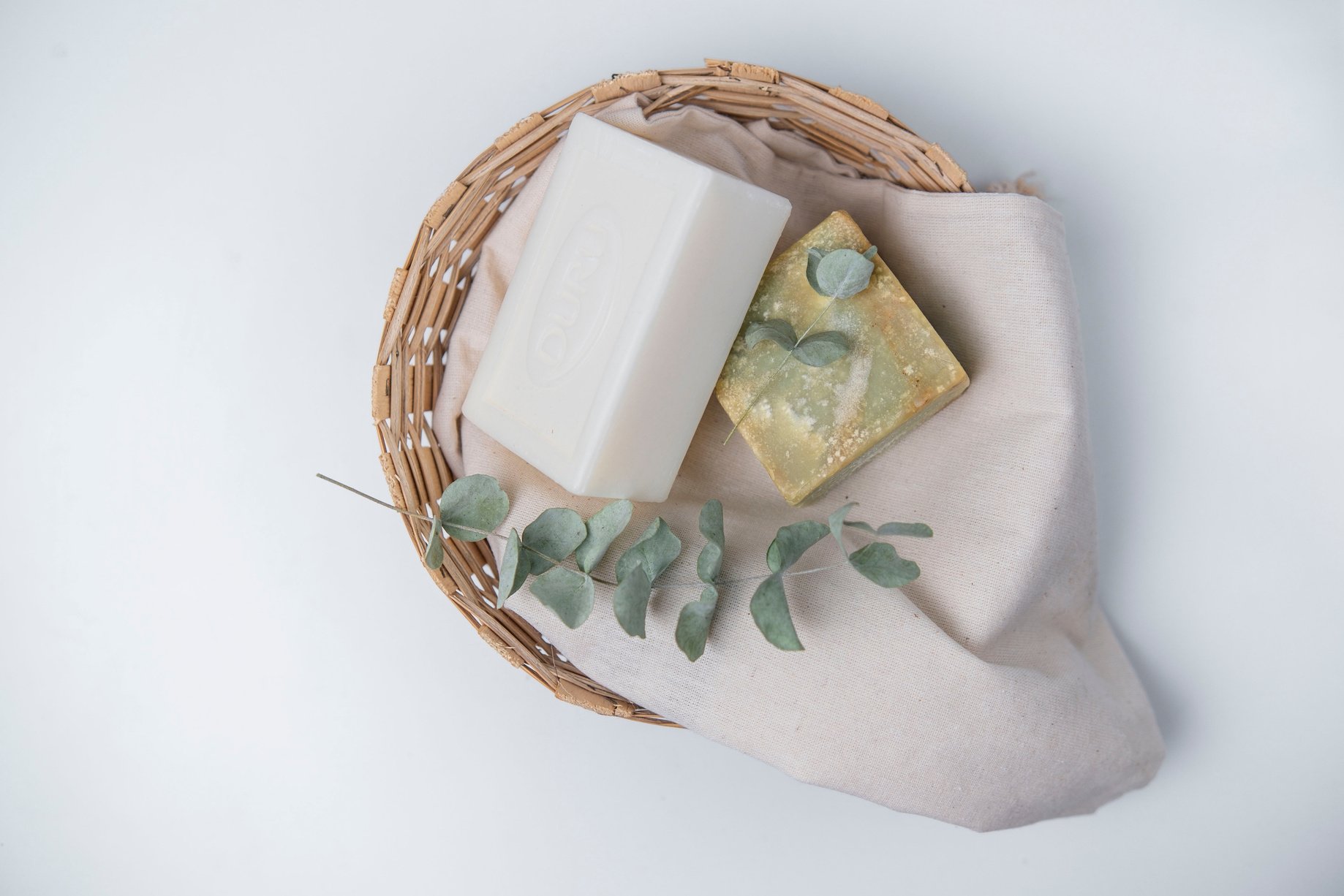 Green Leaves and Soaps on Brown Woven Basket